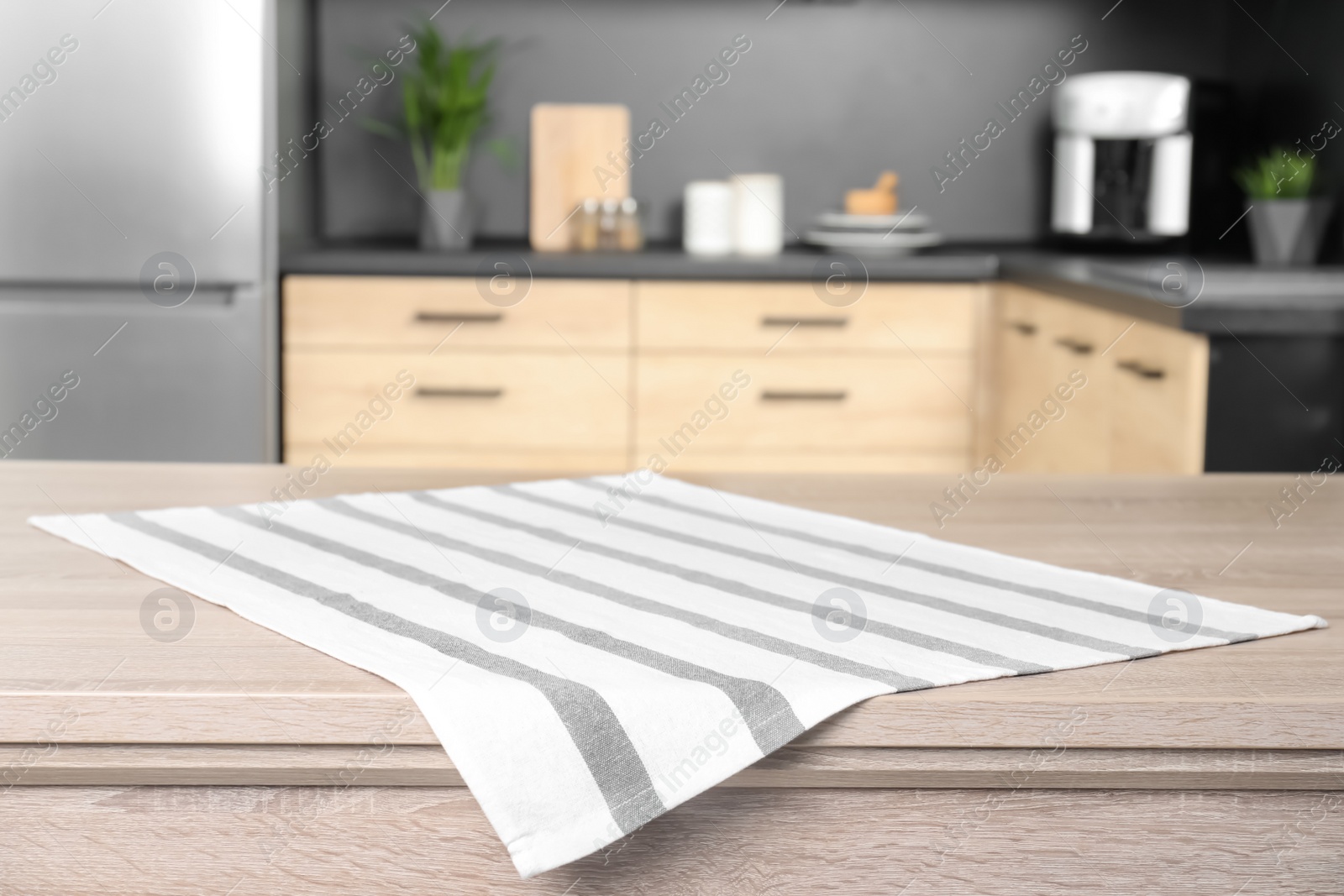 Photo of Napkin on wooden table in kitchen. Mockup for design