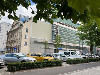 Photo of Different modern cars parked on city street