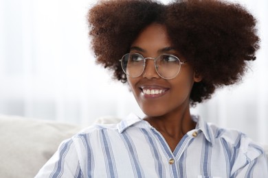 Portrait of smiling African American woman wearing glasses at home