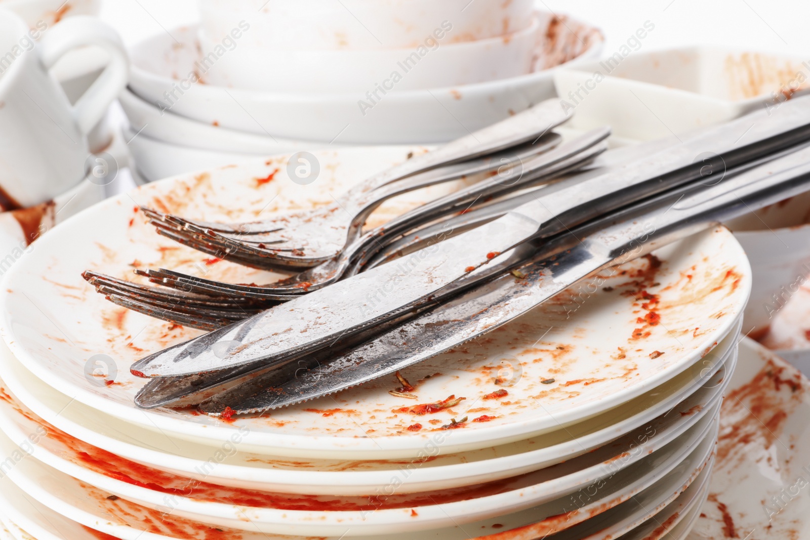 Photo of Pile of dirty dishes and cutlery, closeup