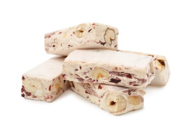 Photo of Many pieces of delicious nougat on white background