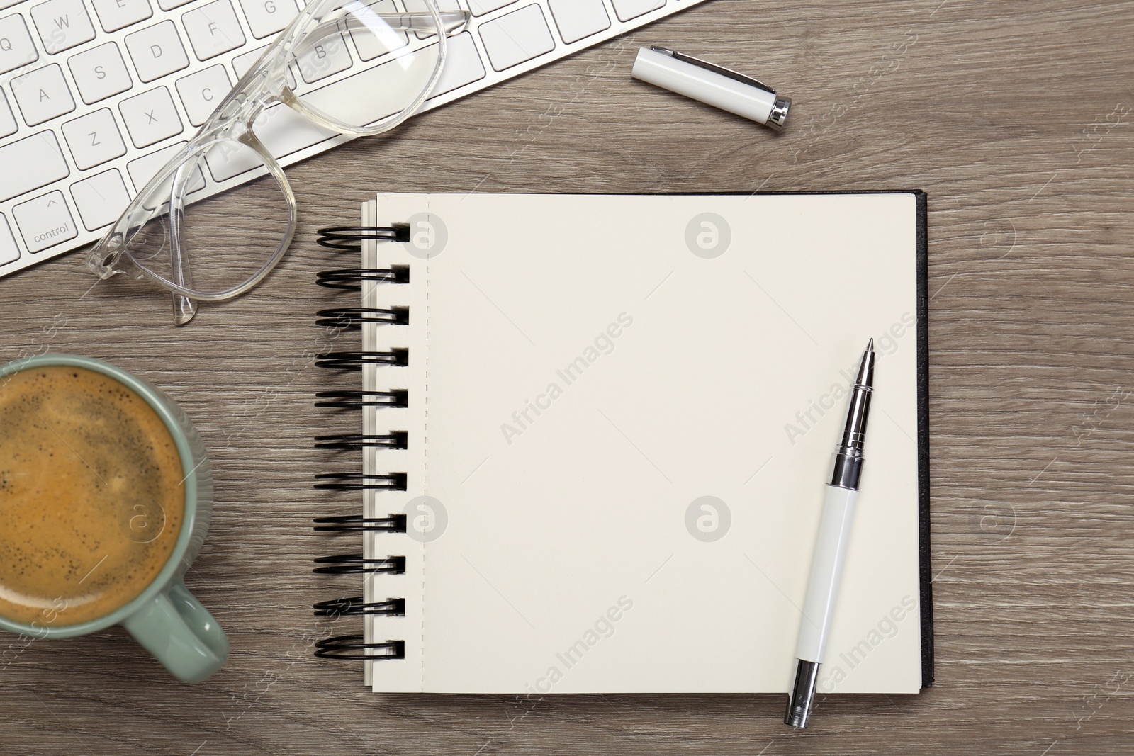 Photo of Flat lay composition with notebook on wooden table