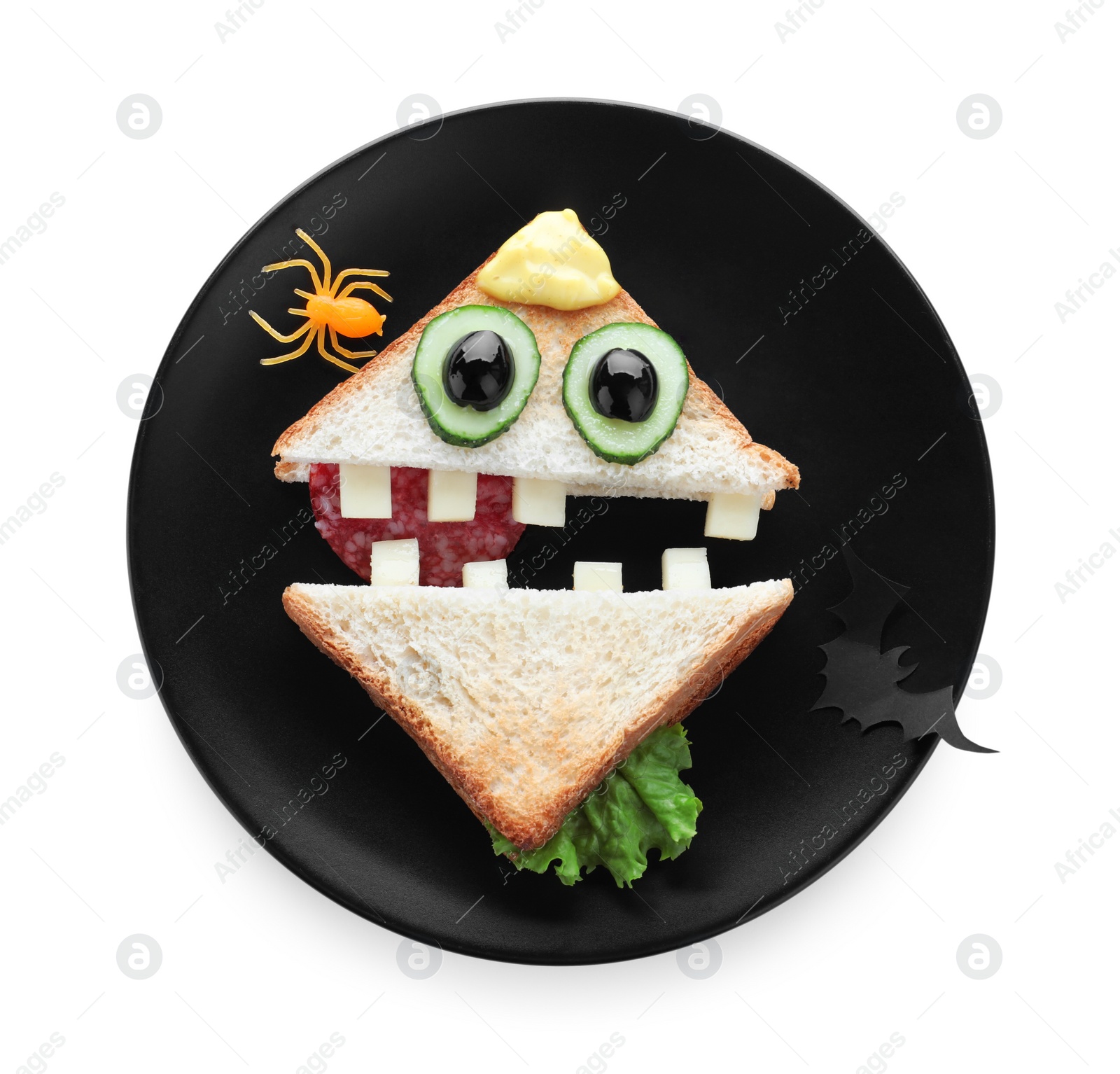 Photo of Cute monster sandwich on white background, top view. Halloween party food