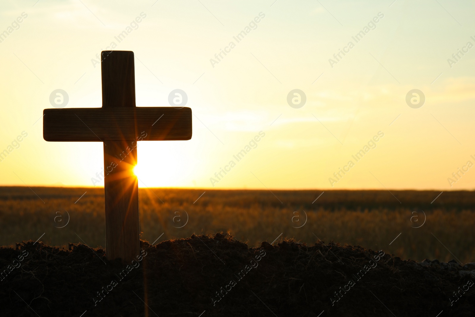 Photo of Silhouette of Christian cross outdoors at sunrise, space for text. Religion concept