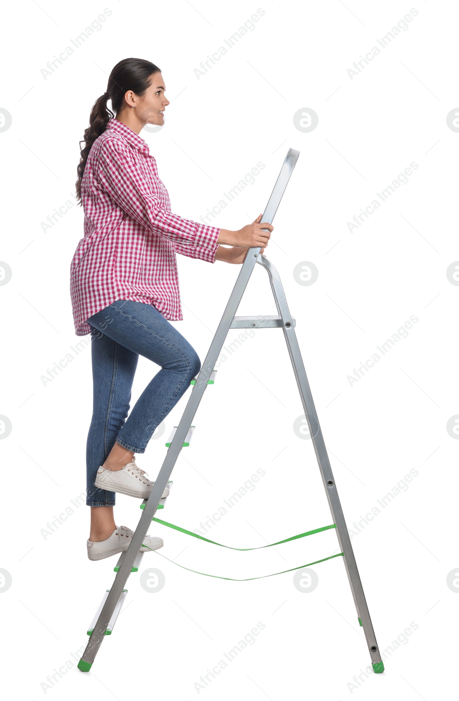 Photo of Young woman climbing up metal ladder on white background