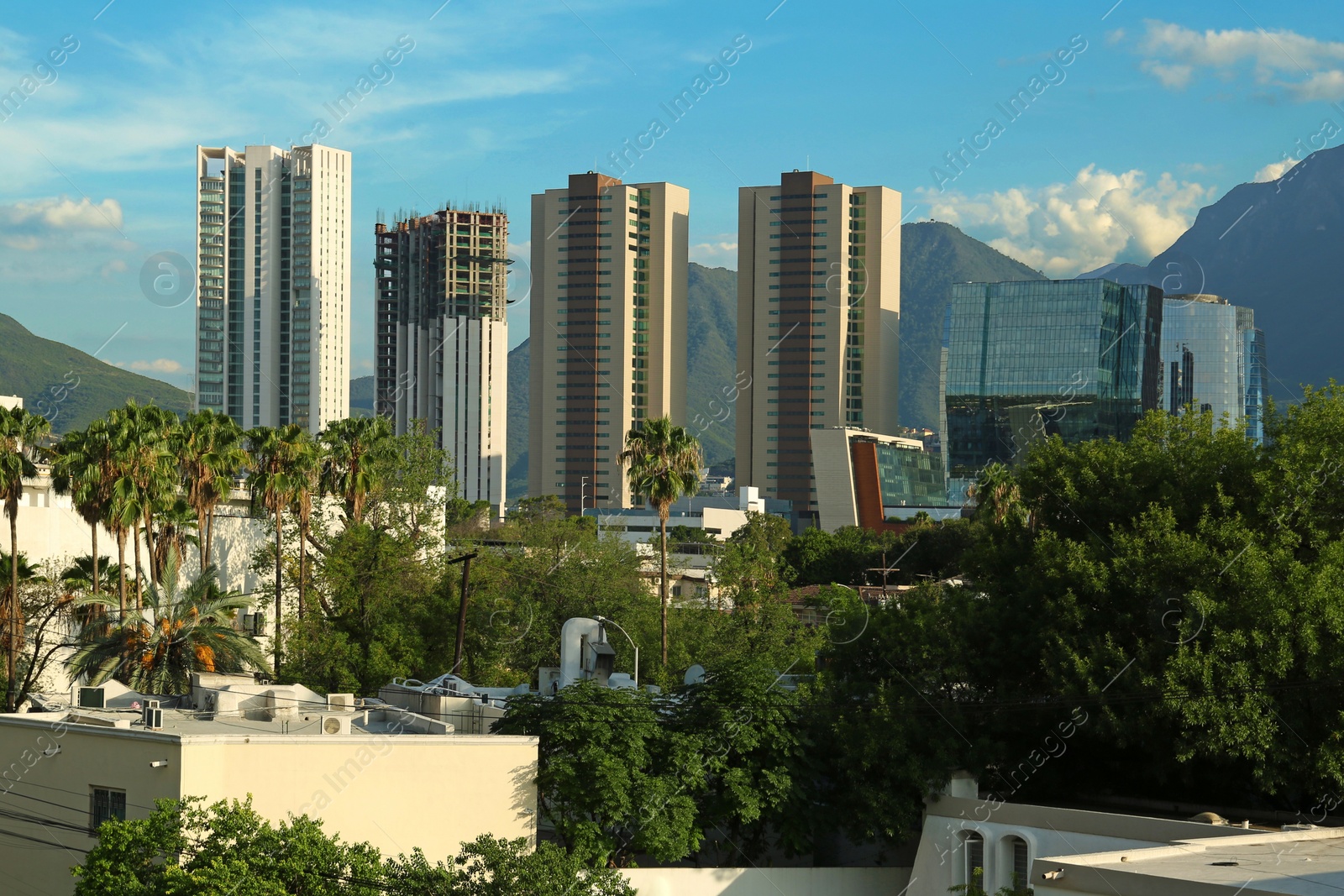 Photo of Picturesque view of mountains and city with skyscrapers