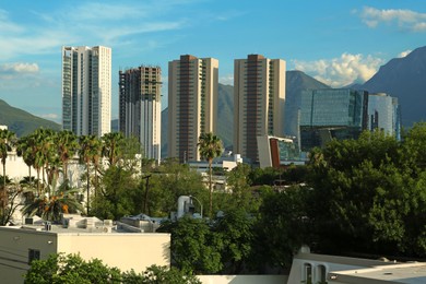 Picturesque view of mountains and city with skyscrapers