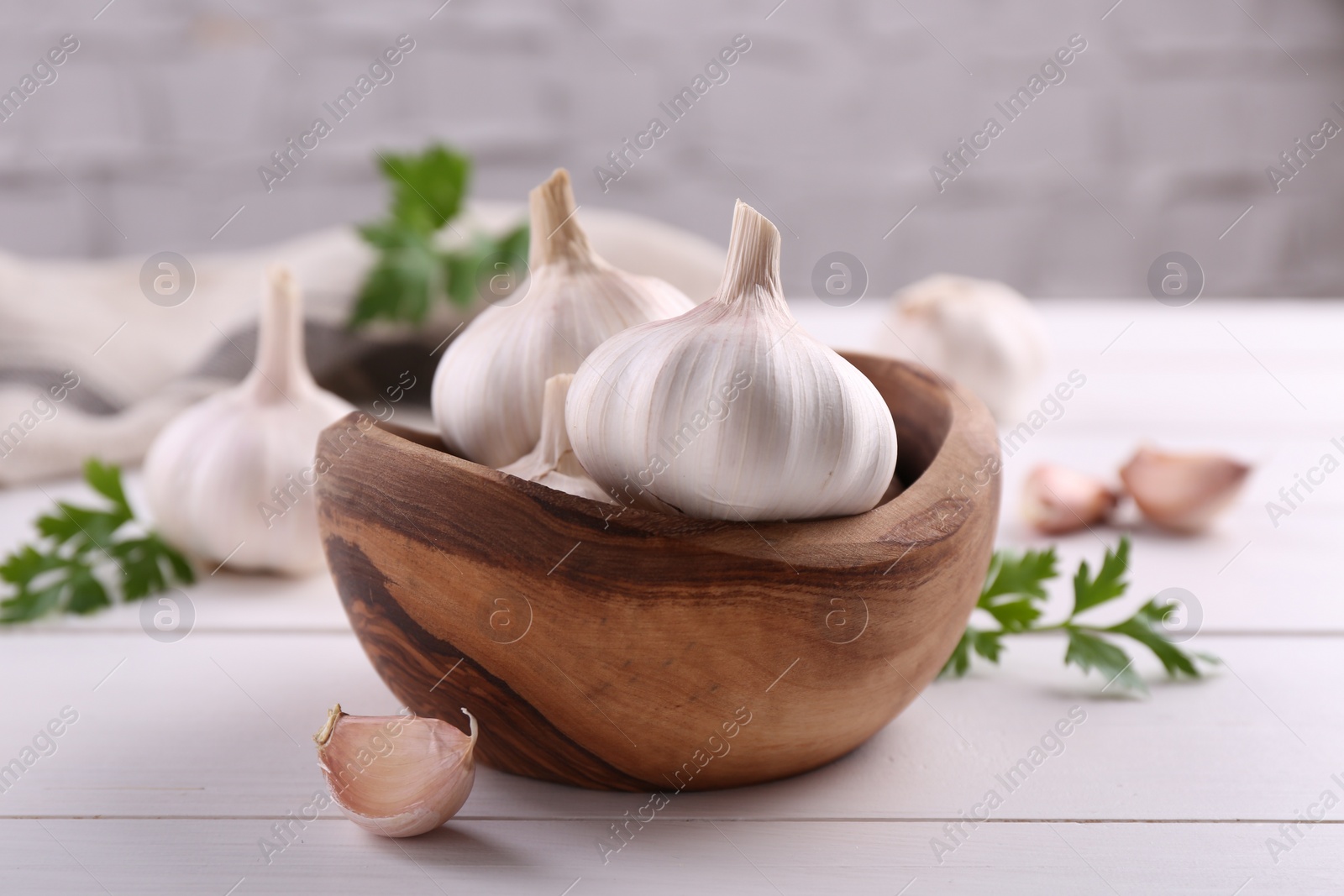 Photo of Fresh garlic on white wooden table, closeup