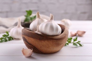 Fresh garlic on white wooden table, closeup