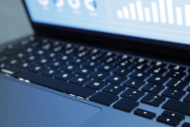 Photo of Laptop on light grey background, closeup. Modern technology