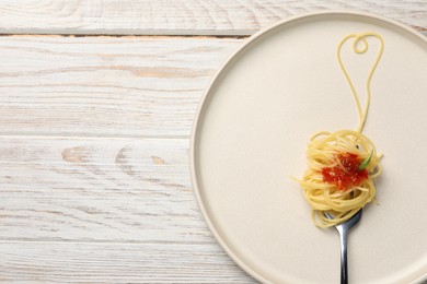 Photo of Heart made with spaghetti and fork on white wooden table, top view. Space for text