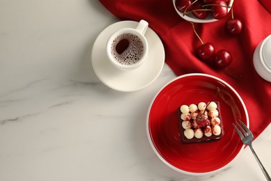 Photo of Piece of delicious red velvet cake served on white marble table, flat lay. Space for text