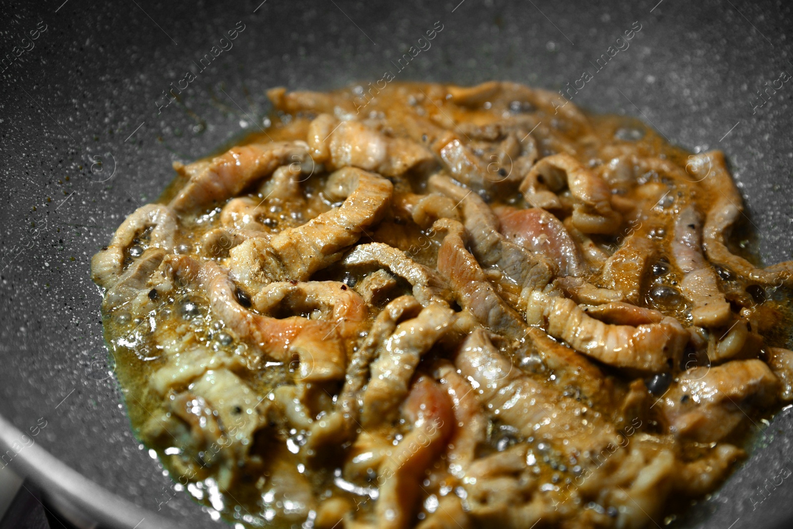 Photo of Cooking delicious meat on frying pan with oil, closeup