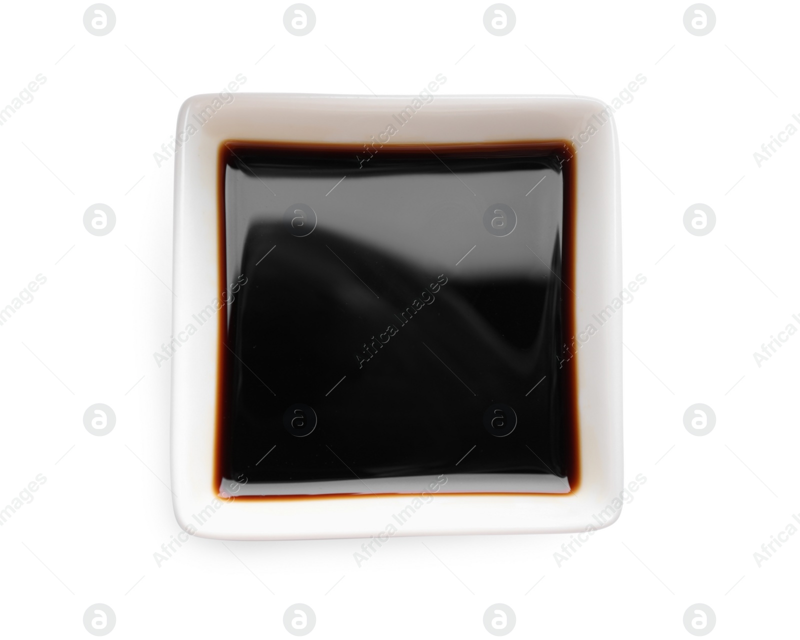 Photo of Soy sauce in bowl isolated on white, top view