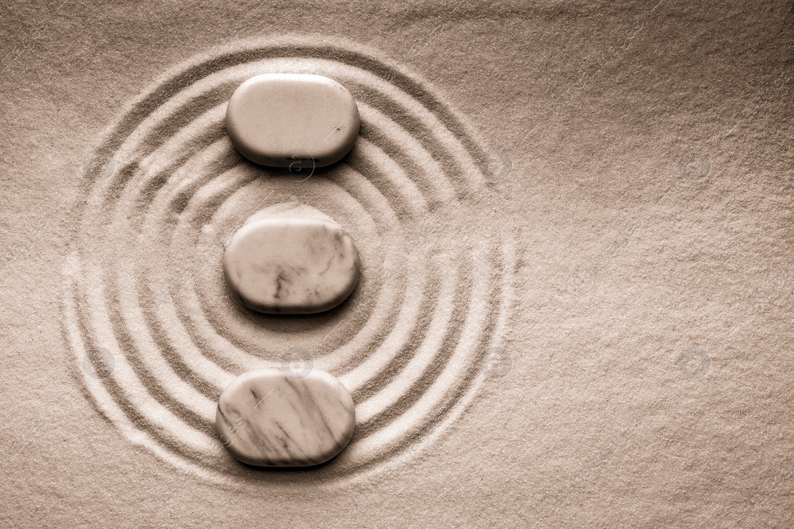 Image of Stones on sand with pattern, flat lay. Zen, meditation, harmony