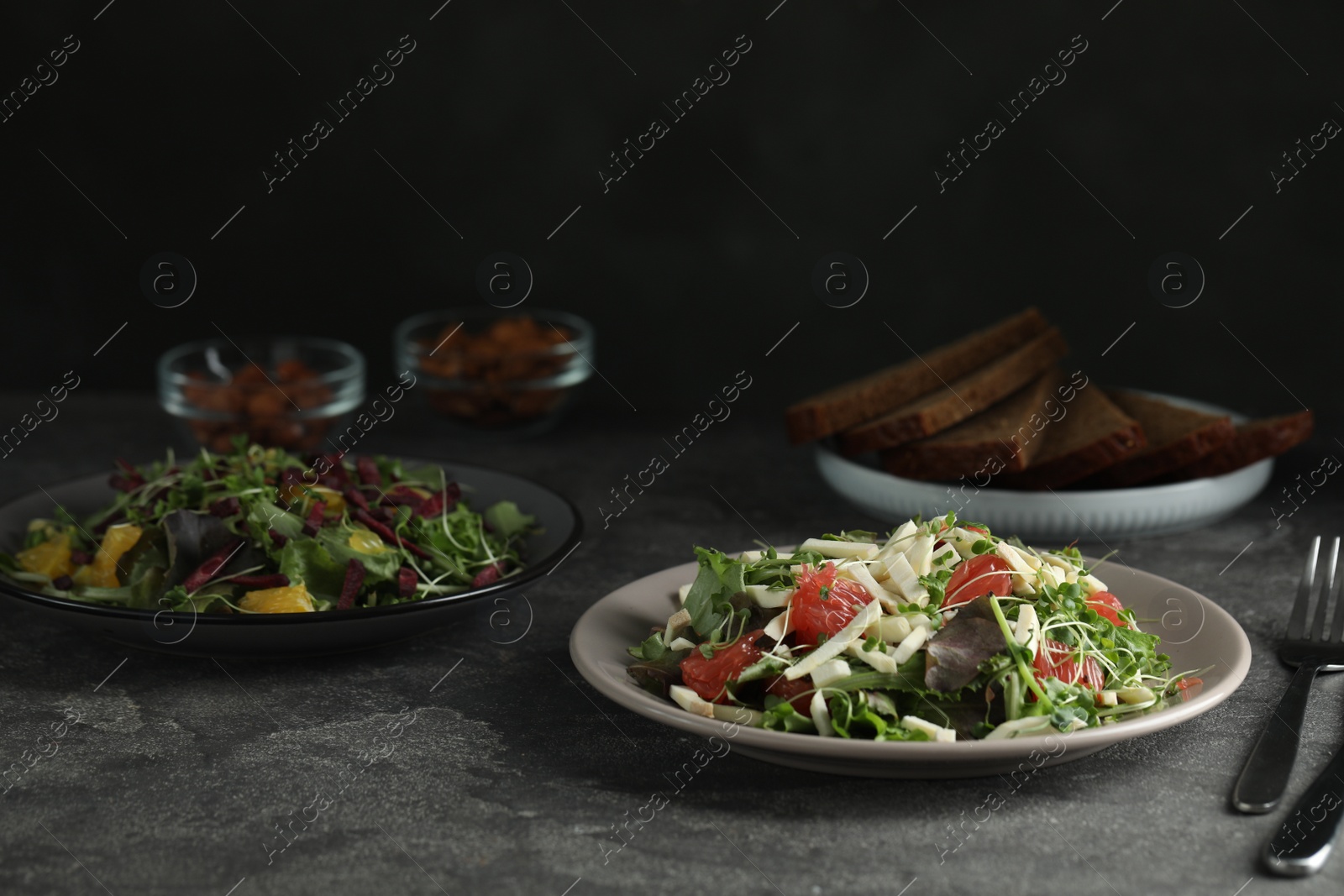 Photo of Delicious carrot salad served on grey table