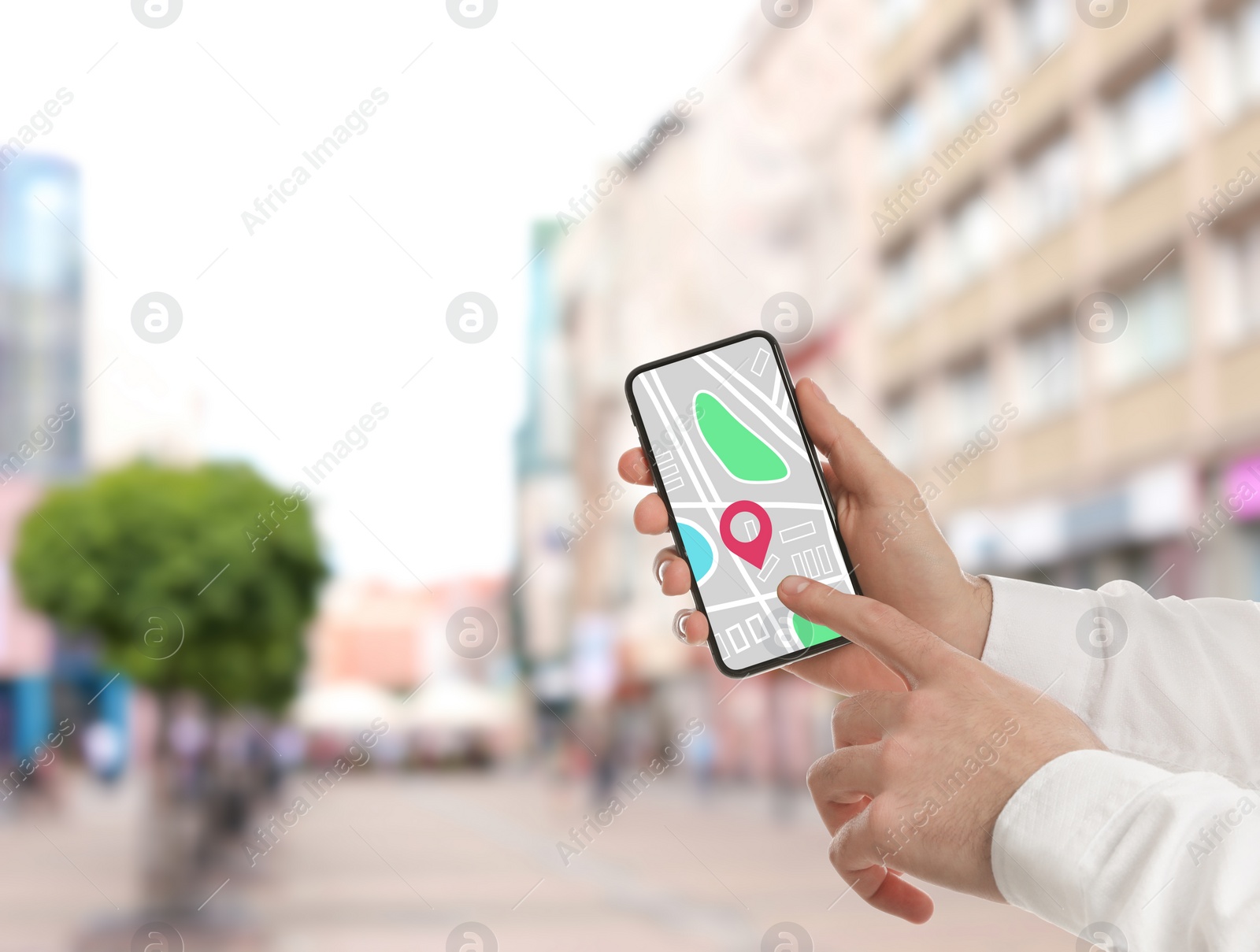 Image of Man searching location with smartphone in city, closeup. Space for text 