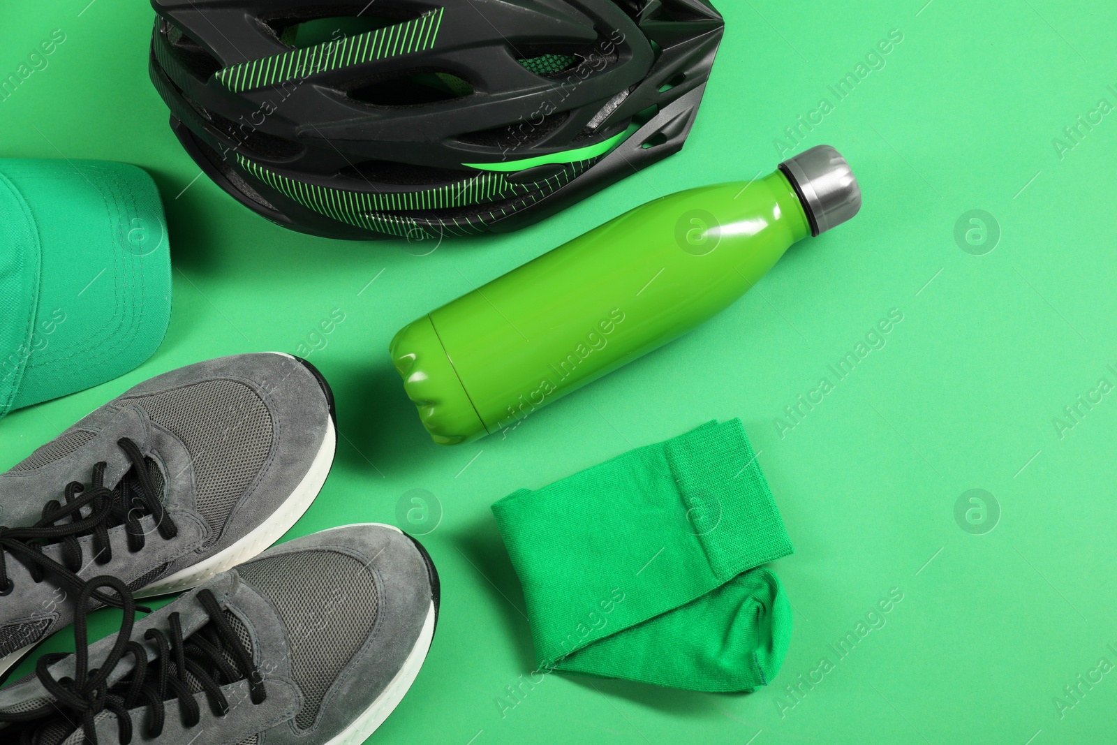 Photo of Different sports equipment on green background, flat lay