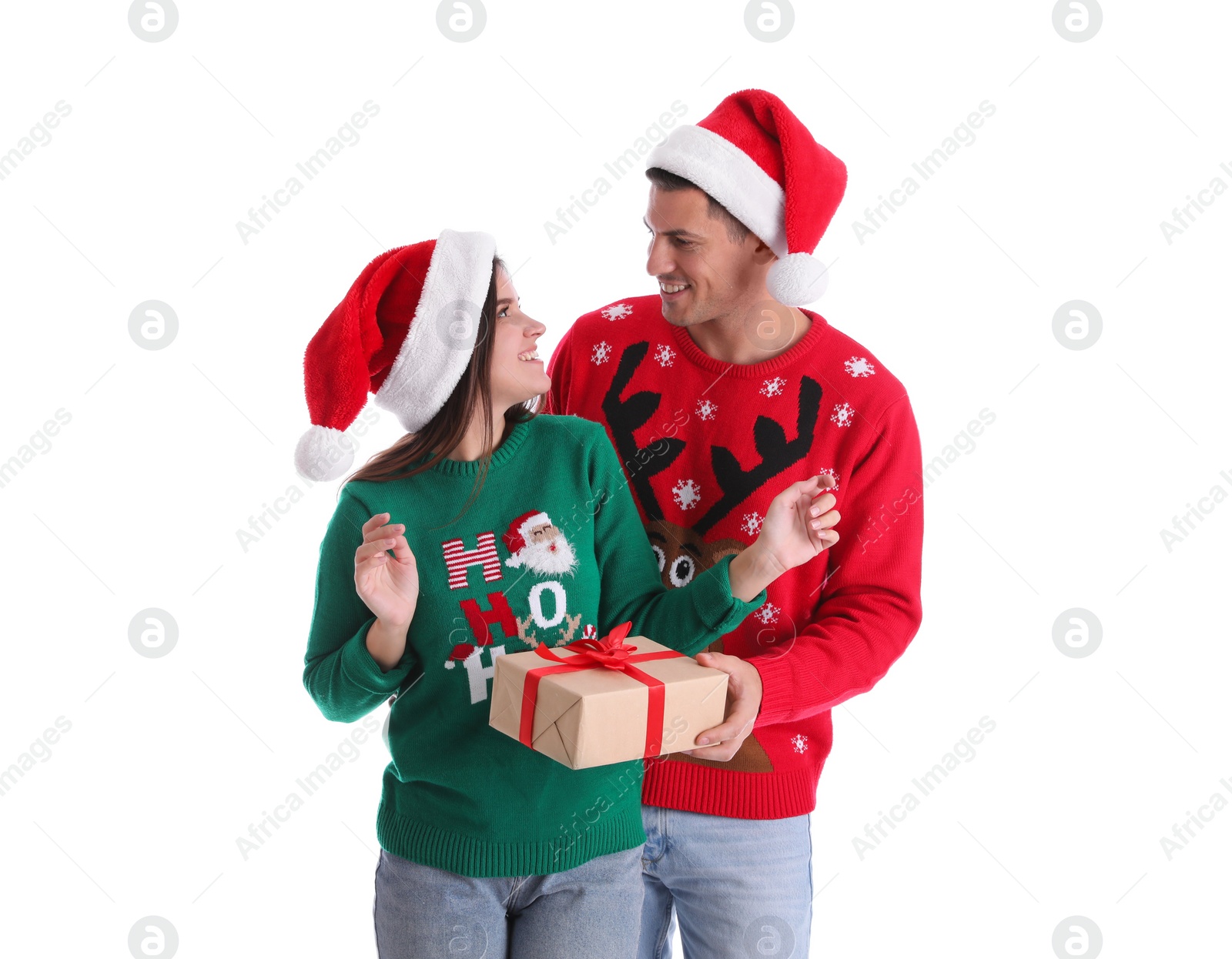 Photo of Man presenting Christmas gift to his girlfriend on white background