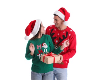 Man presenting Christmas gift to his girlfriend on white background