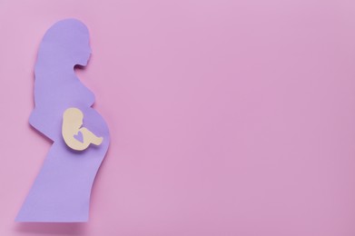 Photo of Woman`s health. Pregnant woman with baby on pale pink background, top view and space for text