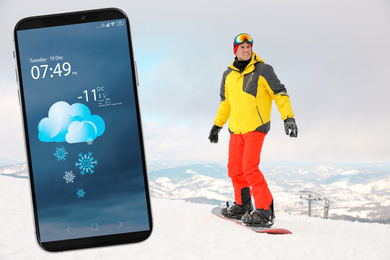 Image of Male snowboarder on snowy hill and smartphone with open weather forecast app 