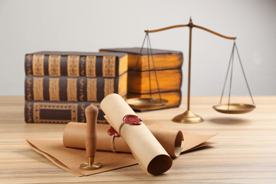 Photo of Notary's public pen and documents with wax stamp on wooden table