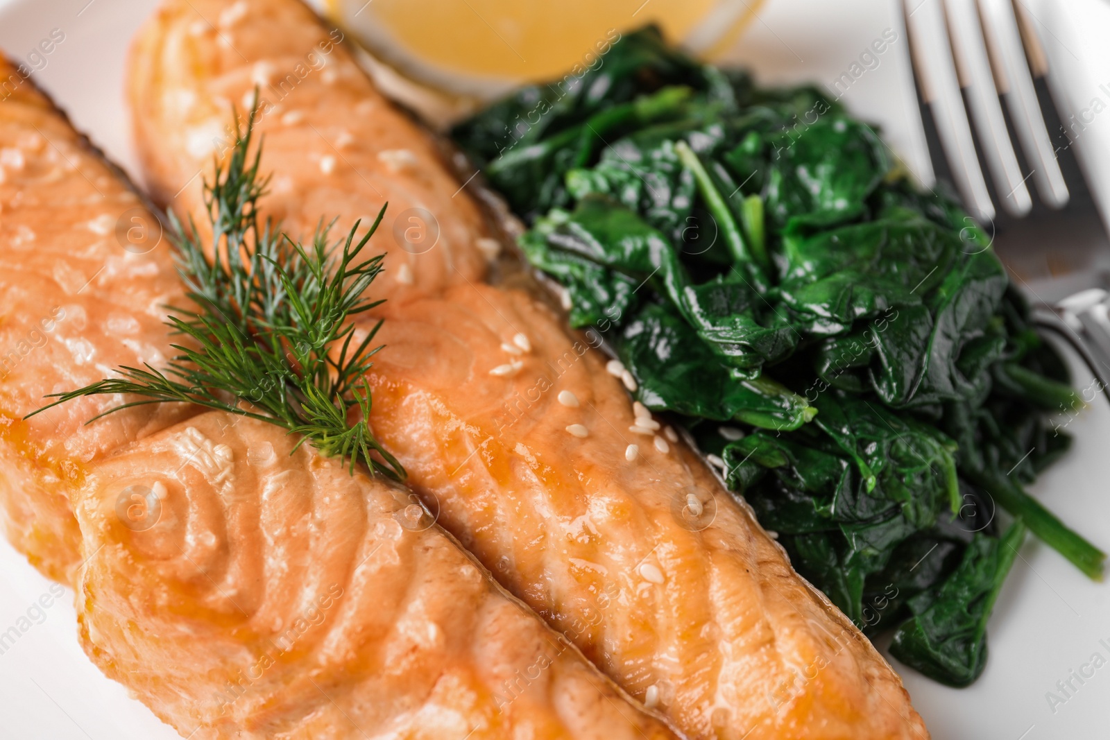 Photo of Closeup view of tasty salmon and spinach