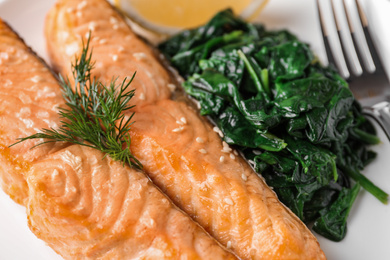 Photo of Closeup view of tasty salmon and spinach