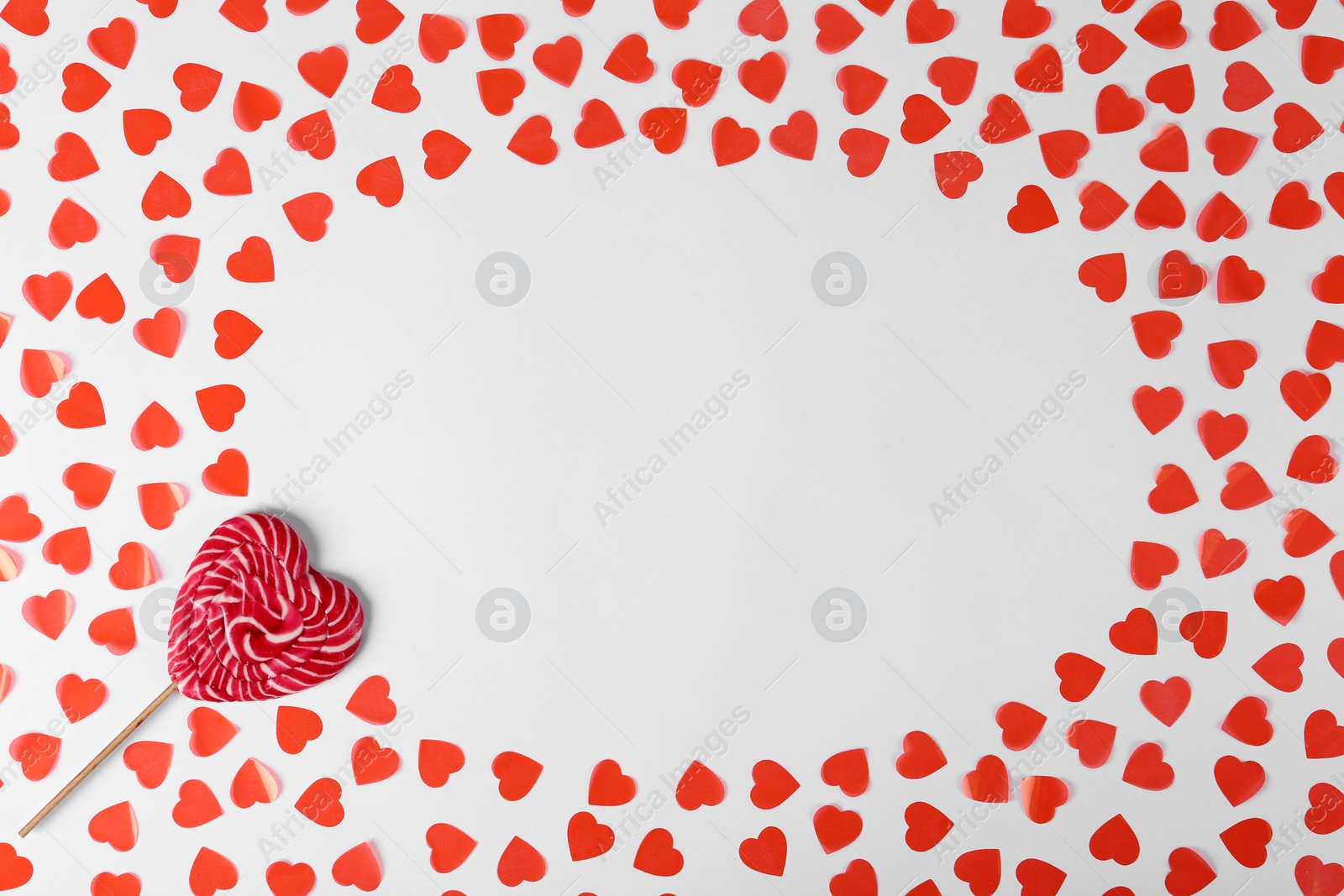 Photo of Composition with sweet lollipop and hearts on white background, top view. Space for text