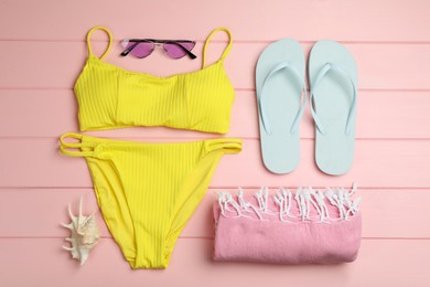 Photo of Flat lay composition with beach objects on pink wooden background