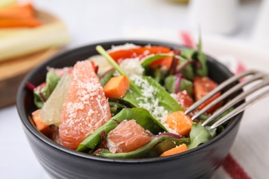 Photo of Delicious salad with pomelo, tomatoes and cheese in bowl, closeup