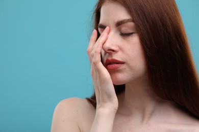 Photo of Portrait of beautiful woman with freckles on light blue background, closeup. Space for text