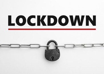 Image of Concept of lockdown due to Coronavirus pandemic. Steel padlock and chain isolated on white, top view