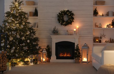 Stylish living room interior with decorated Christmas tree and comfortable sofa