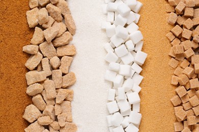 Different types of sugar as background, top view