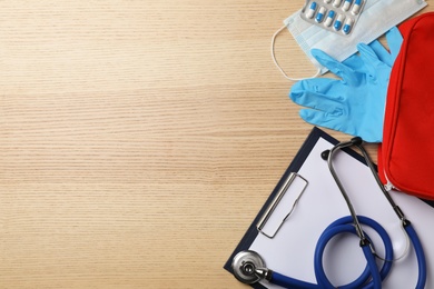 Photo of Flat lay composition with medical objects and space for text on wooden background