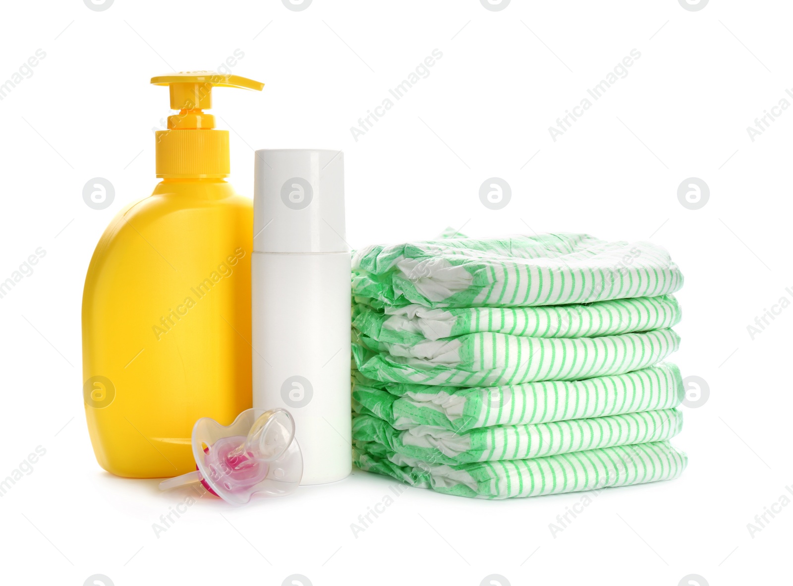 Photo of Stack of disposable diapers and baby accessories on white background