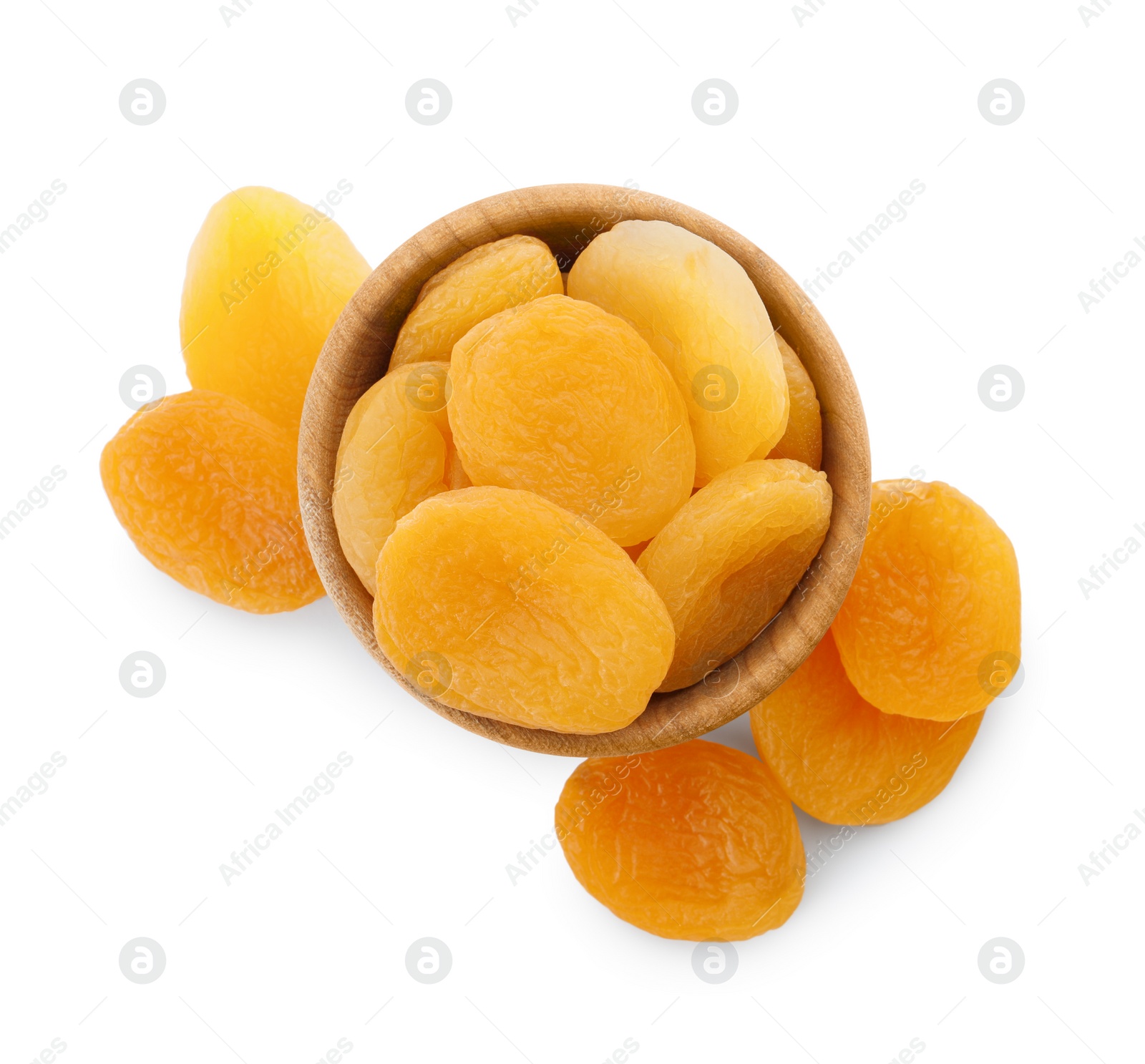 Photo of Wooden bowl with dried tasty apricots isolated on white, top view