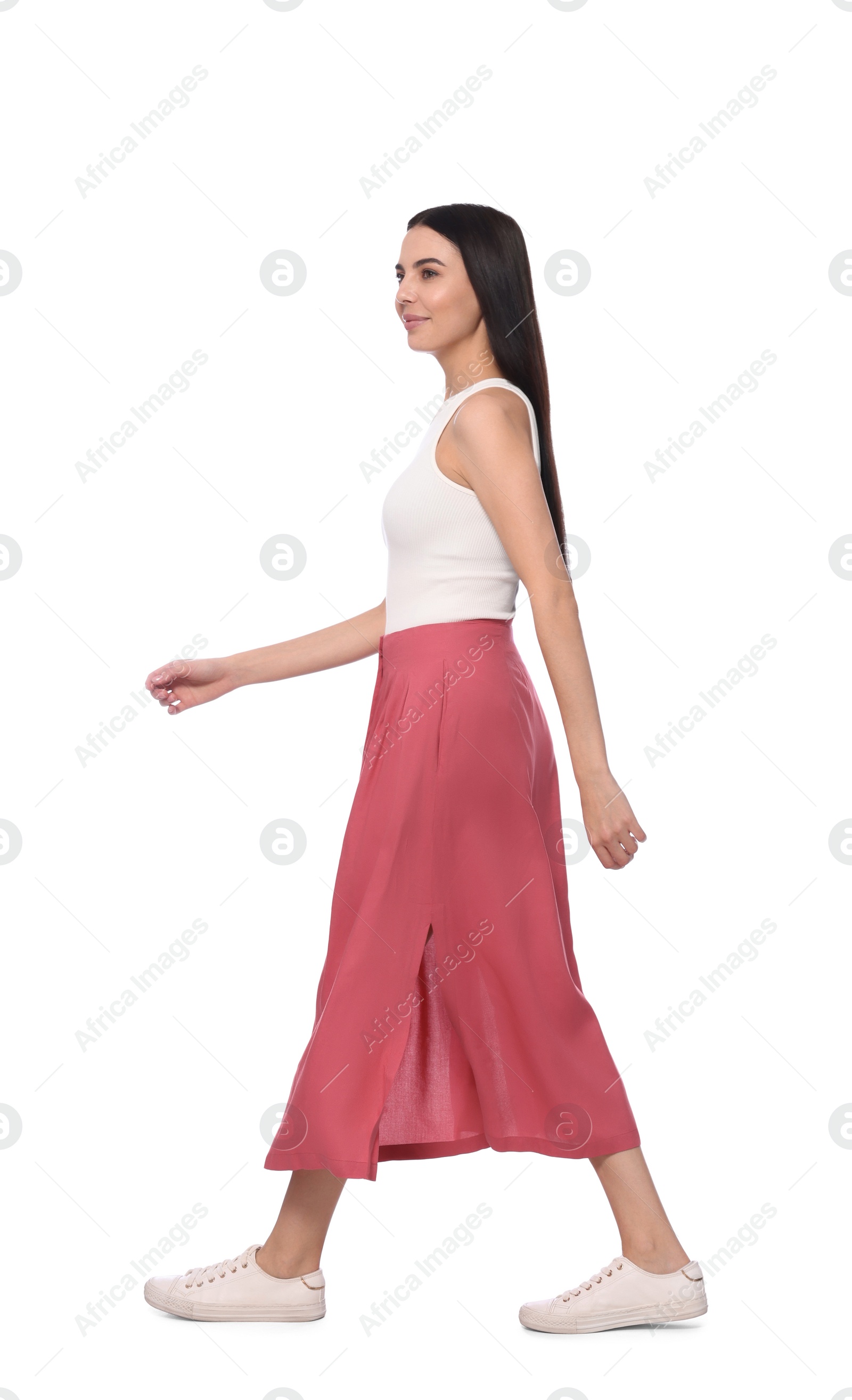 Photo of Woman in casual outfit walking on white background
