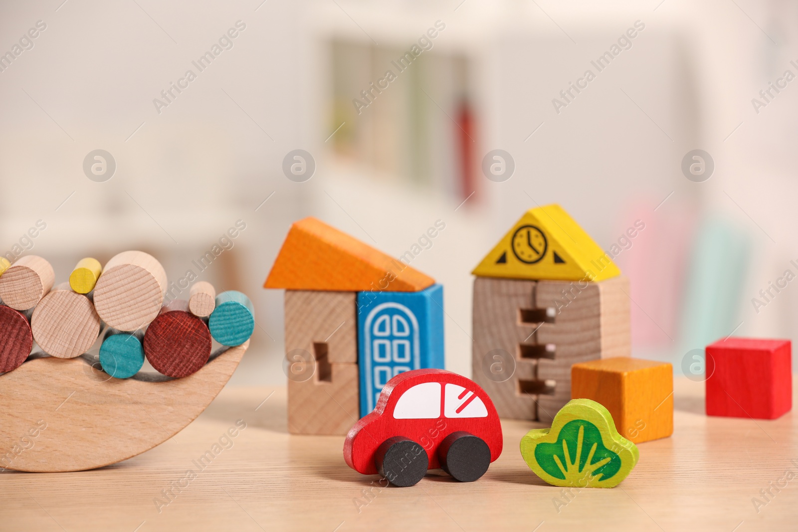 Photo of Set of wooden toys on table indoors, closeup. Children's development