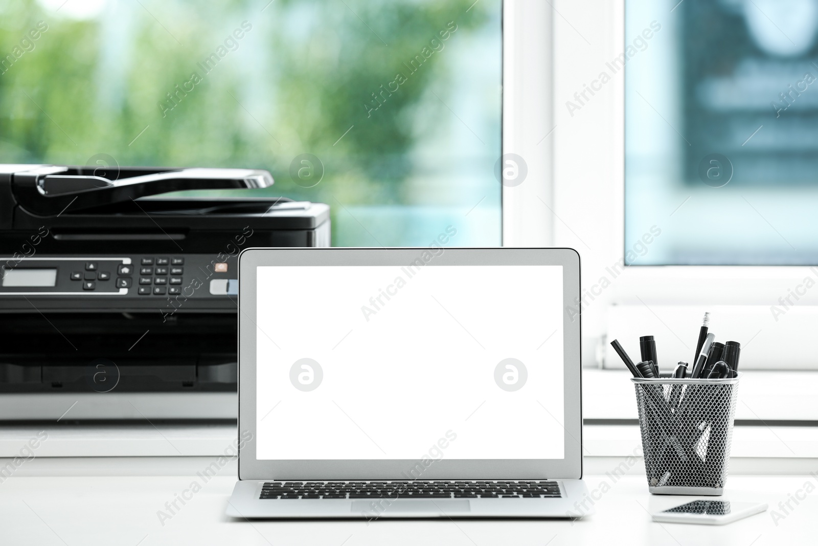 Photo of Modern laptop on desk in room. Home workplace