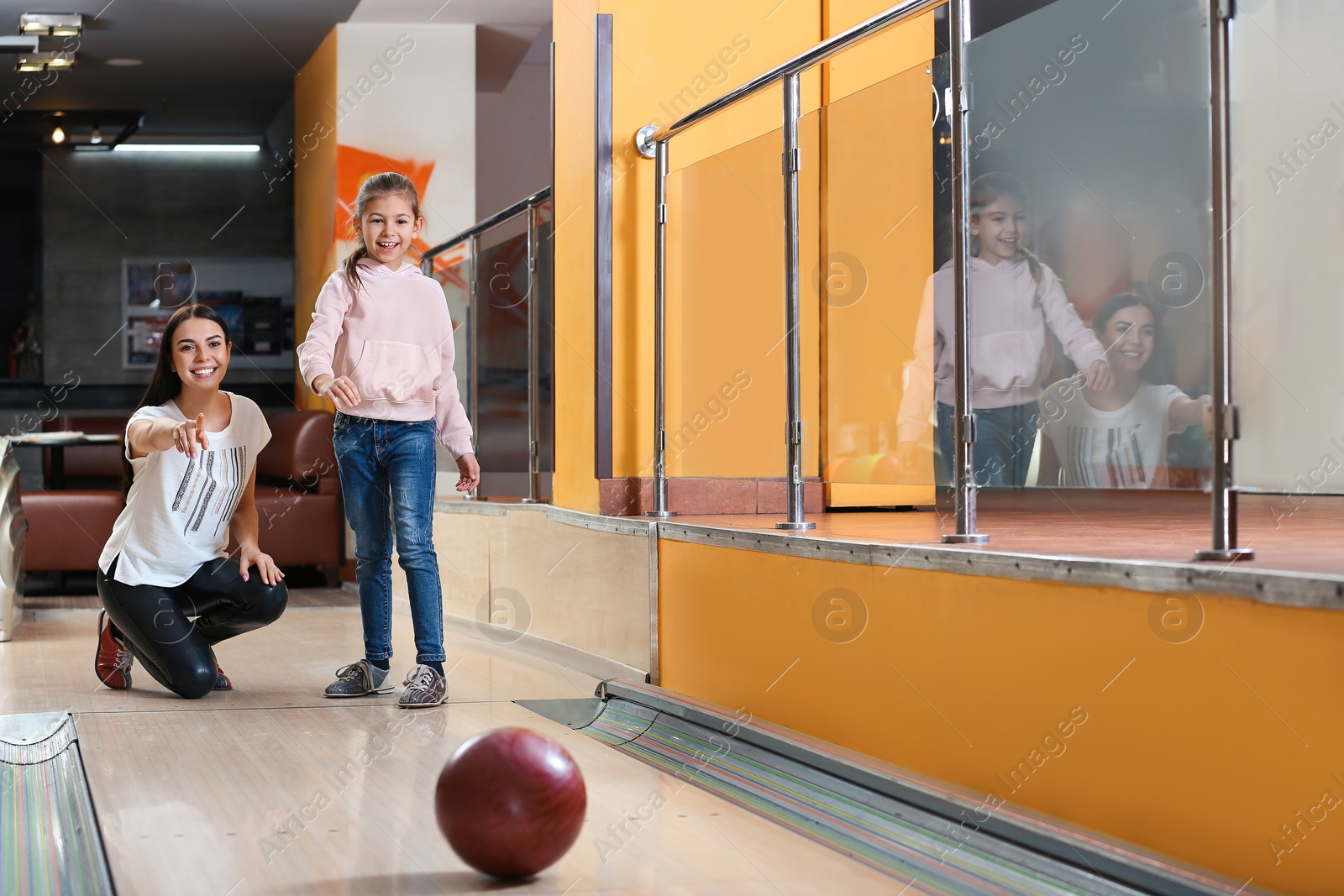 Photo of Mother and daughter spending time together in bowling club