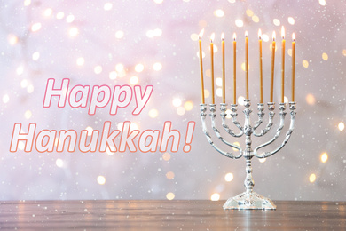 Silver menorah on wooden table. Happy Hanukkah!