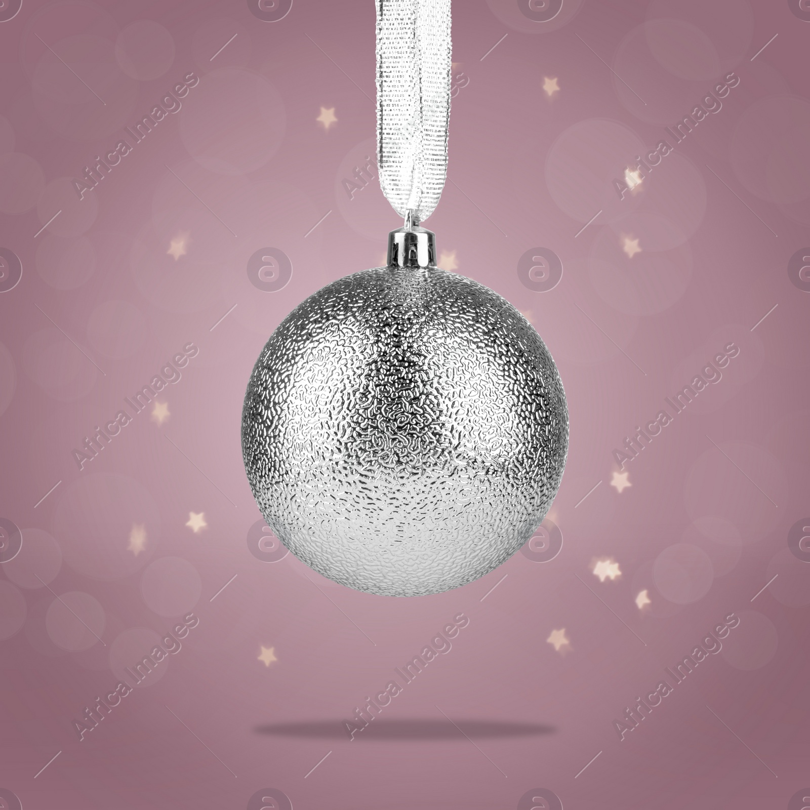 Image of Beautiful silver Christmas ball hanging on color background