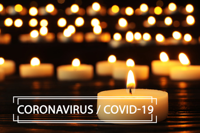 Funeral ceremony devoted to coronavirus victims. Burning candles on table
