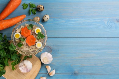 Photo of Delicious aspic with meat and vegetables served on light blue wooden table, flat lay. Space for text