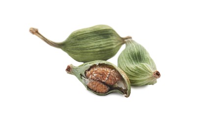 Dry green cardamom pods on white background, closeup