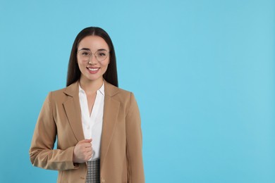 Beautiful woman wearing glasses on turquoise background, space for text