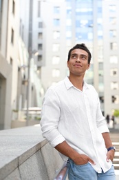 Photo of Handsome young African-American man on city street